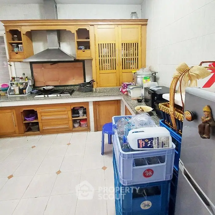 Spacious kitchen with wooden cabinets and modern appliances, ideal for culinary enthusiasts.