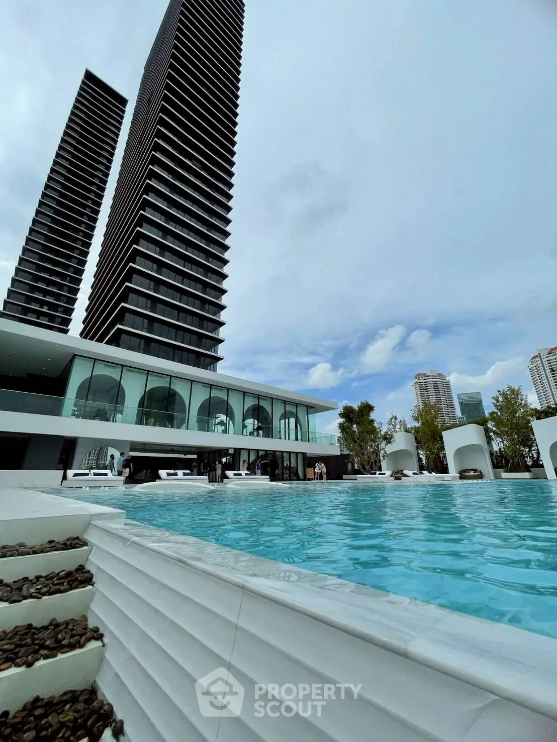 Luxurious high-rise building with stunning pool and modern architecture