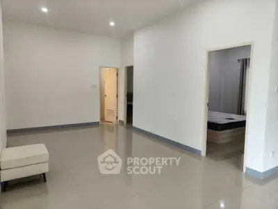 Spacious modern living area with sleek tile flooring and minimalist design