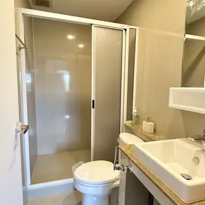 Modern bathroom with shower and sleek fixtures in a contemporary home.