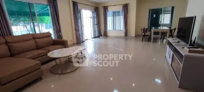 Spacious living room with modern furniture and large windows for natural light.
