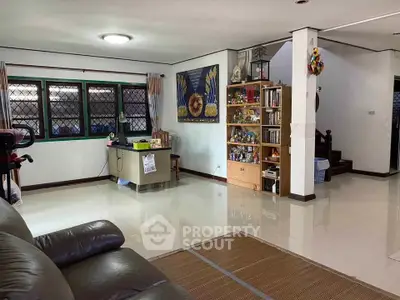 Spacious living room with modern decor and ample natural light