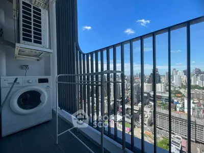 High-rise balcony with stunning city view and washing machine setup.