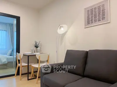 Modern living room with cozy sofa and dining area in stylish apartment