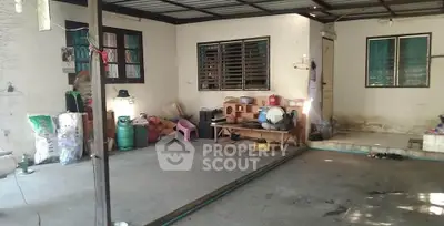 Spacious covered outdoor area with potential for renovation or storage, featuring basic amenities and ample space.