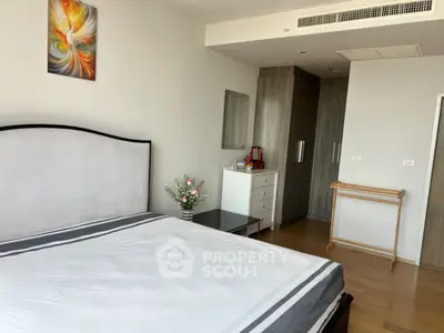 Spacious modern bedroom with elegant decor and ample storage space.