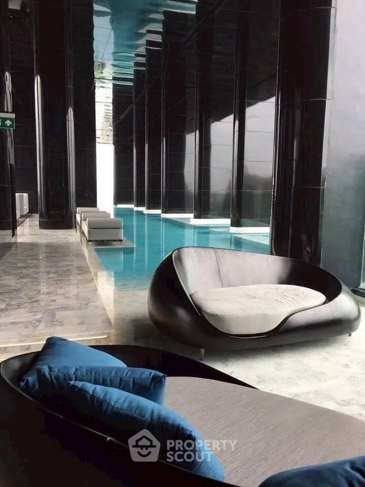 Luxurious indoor pool area with modern seating and sleek design