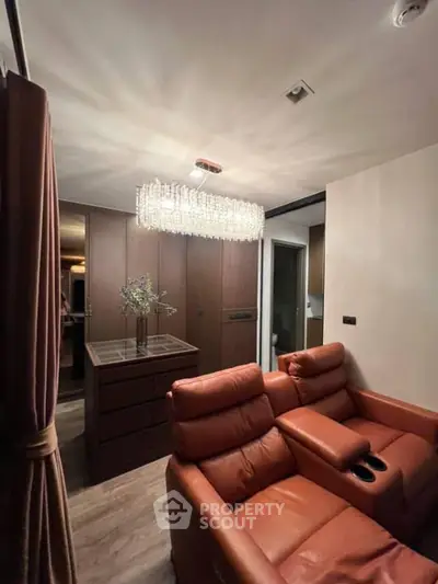 Luxurious living room with leather recliners and elegant chandelier