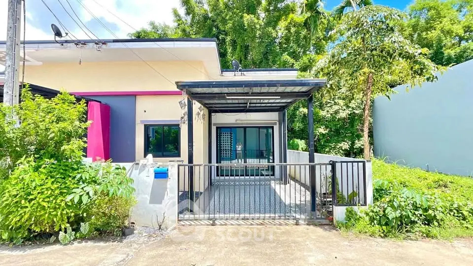 Charming single-story home with vibrant facade and lush greenery, perfect for modern living.