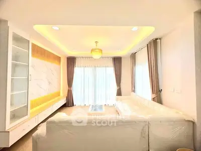 Elegant living room with modern lighting and large windows