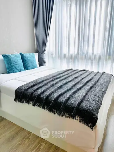 Modern bedroom with stylish decor and large window for natural light