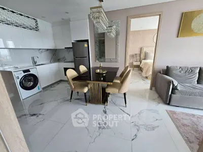 Modern open-plan kitchen and living area with elegant dining set and marble flooring