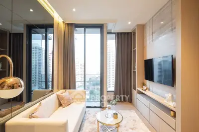 Luxurious modern living room with city view, elegant decor, and cozy ambiance.