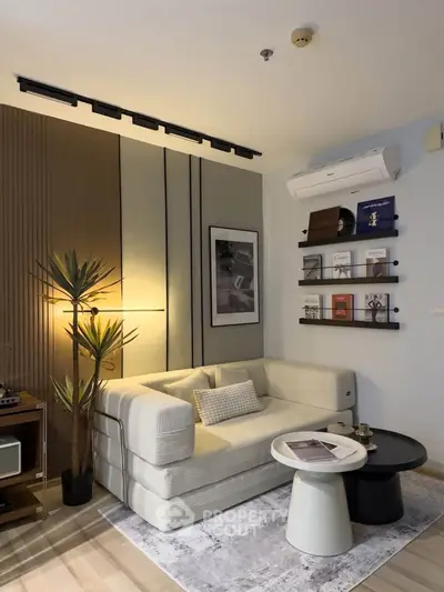 Modern living room with stylish decor, featuring a cozy sofa, wall-mounted shelves, and ambient lighting.