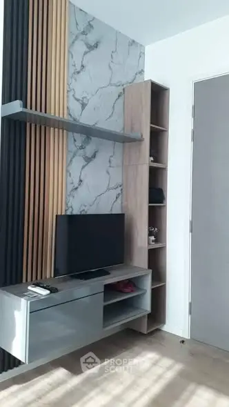 Modern living room with stylish TV unit and marble accent wall