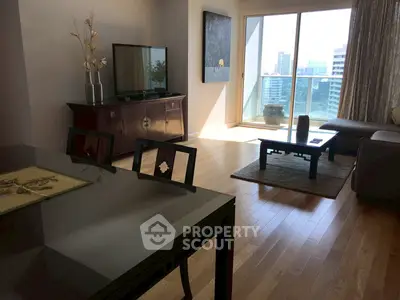 Spacious living room with modern decor and city view balcony.