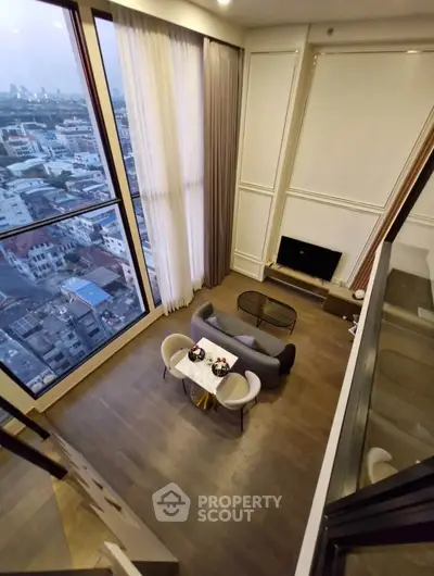 Stunning high-rise living room with floor-to-ceiling windows and breathtaking city views.