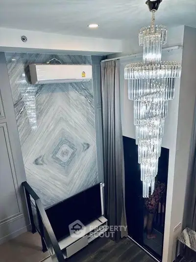 Luxurious modern living room with stunning chandelier and elegant decor