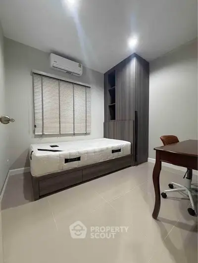 Modern bedroom with sleek furniture and air conditioning unit
