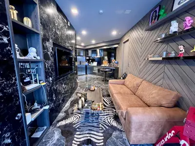 Luxurious living room with modern decor, marble accents, and stylish furniture, perfect for sophisticated urban living.