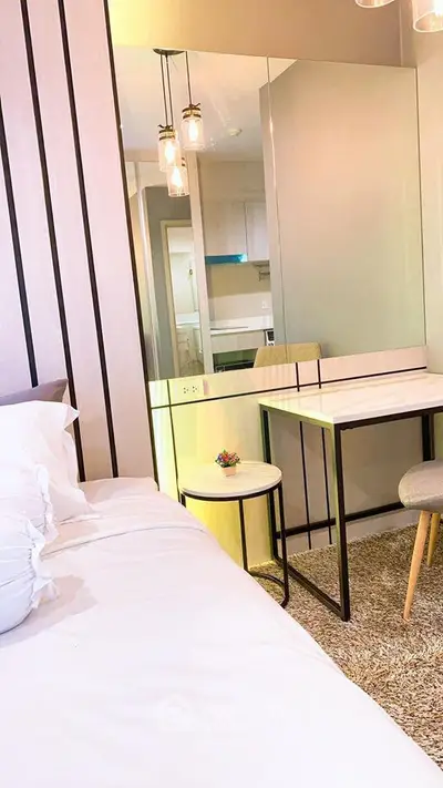 Modern bedroom with stylish decor and cozy ambiance, featuring a sleek desk and comfortable bed.