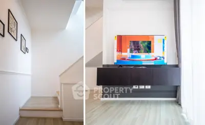 Modern interior with sleek staircase and wall-mounted TV in bright living space.
