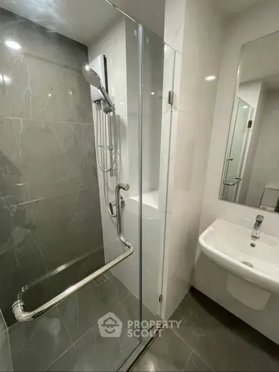 Modern bathroom with glass shower and sleek fixtures