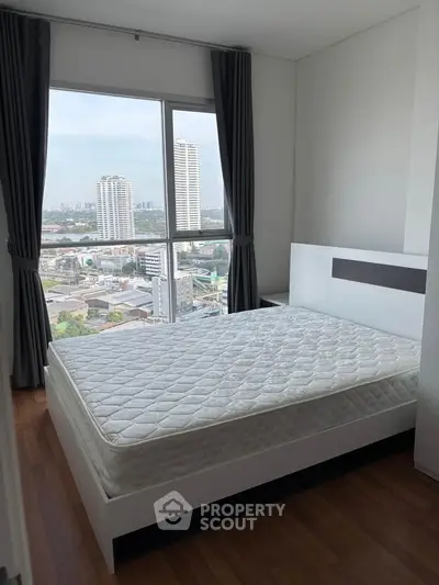 Cozy bedroom with city view and large window, featuring a comfortable bed and modern design.