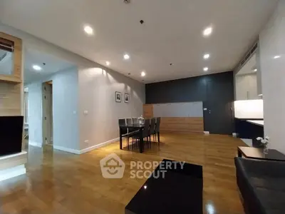Spacious modern living room with wooden flooring and elegant dining area