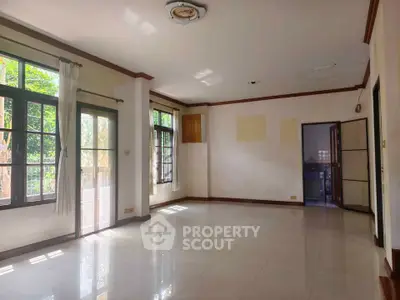 Spacious empty living room with large windows and natural light