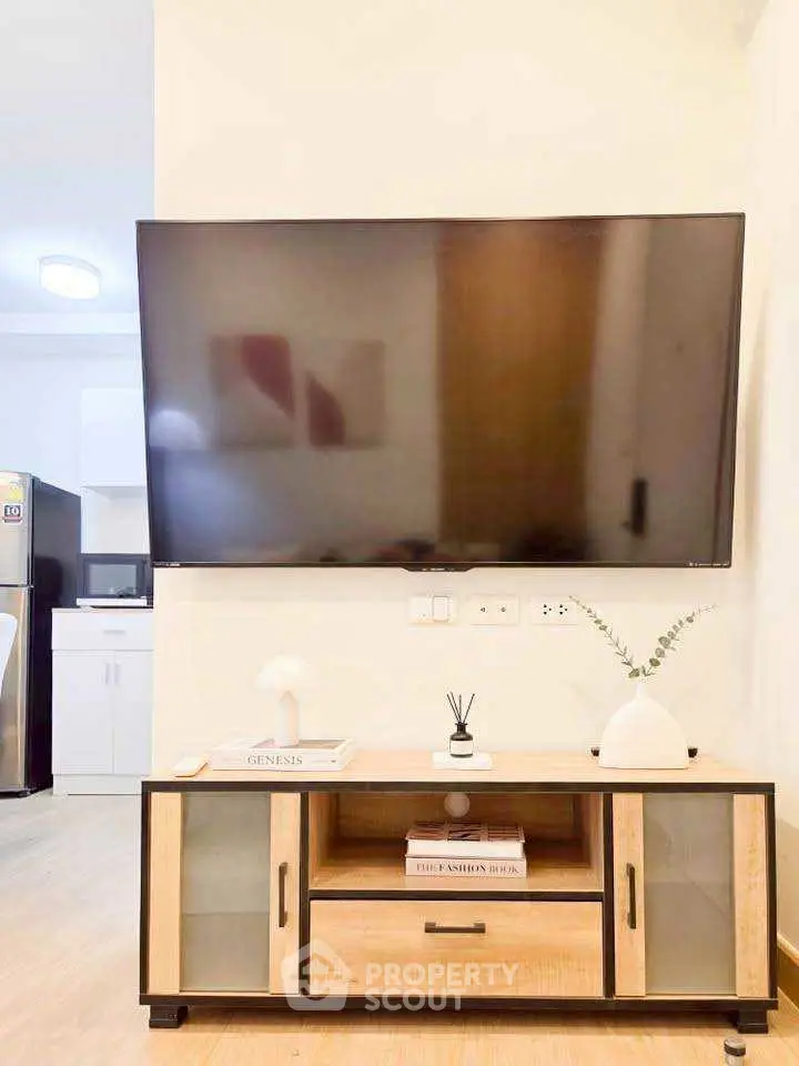 Modern living room with wall-mounted TV and stylish wooden cabinet