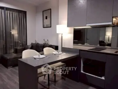 Modern open-plan kitchen and living area with sleek design and cozy ambiance.