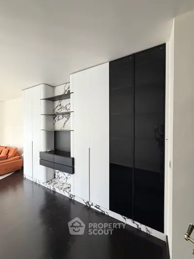 Modern living room with sleek built-in storage and stylish marble accents