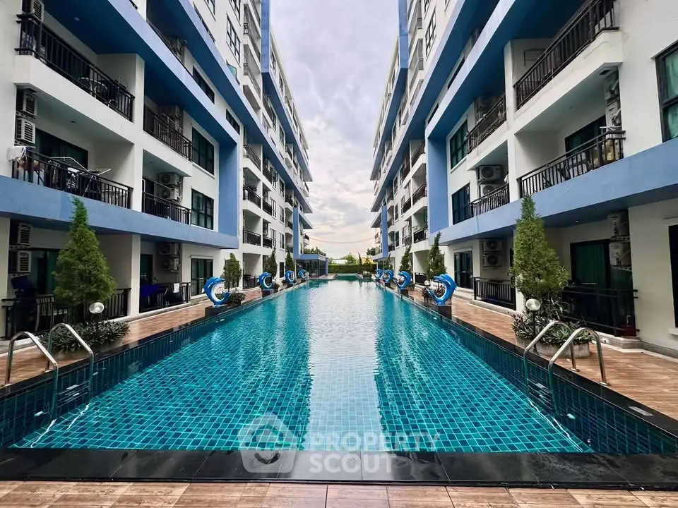 Luxurious apartment complex with stunning outdoor pool and modern architecture.
