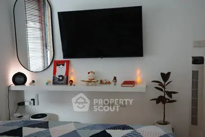 Cozy bedroom with modern decor and wall-mounted TV