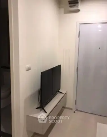 Compact modern living space with wall-mounted TV and sleek design
