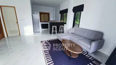 Modern living room with sleek furniture and open kitchen layout