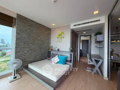 Modern living room with stylish decor and city view, featuring a cozy seating area and elegant wooden flooring.
