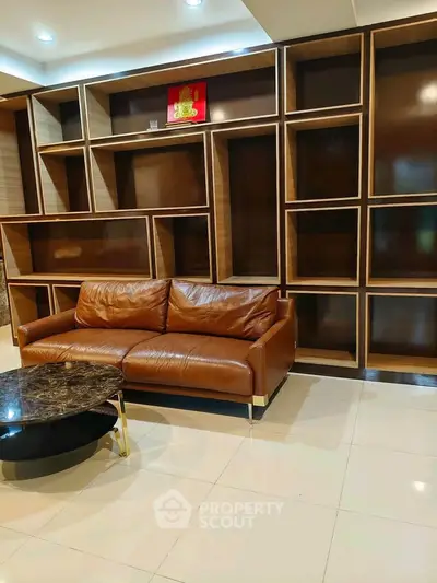 Modern living room with stylish leather sofa and unique shelving unit