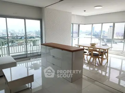Spacious modern living room with panoramic city view and elegant dining area