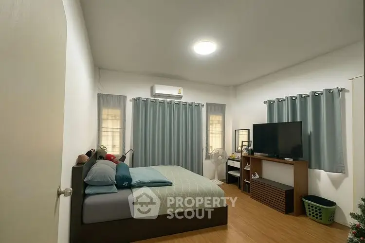 Cozy bedroom with modern decor and ample natural light