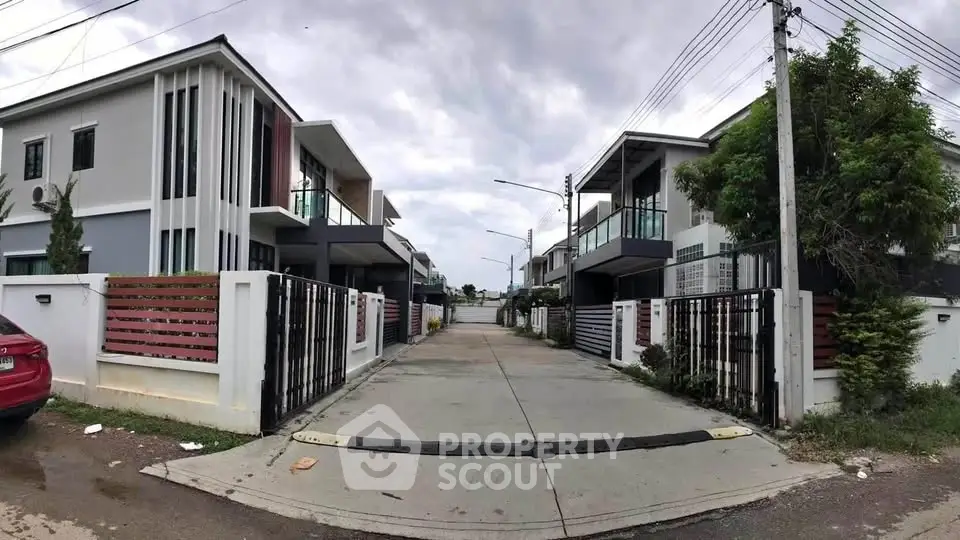 Modern residential complex with contemporary architecture and gated entrance.