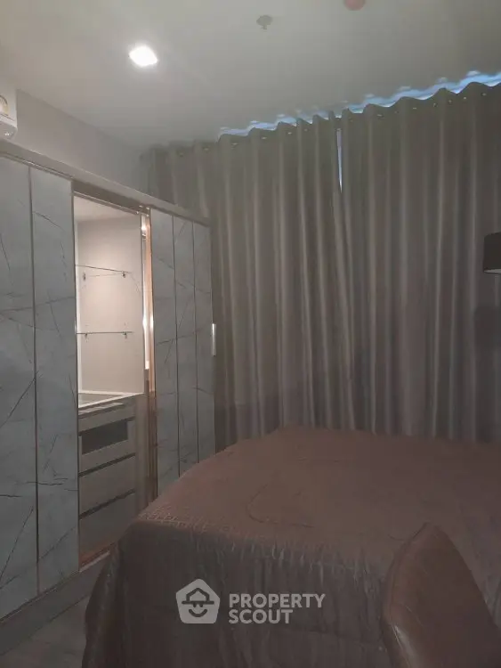 Cozy bedroom with modern wardrobe and elegant curtains, perfect for restful nights.