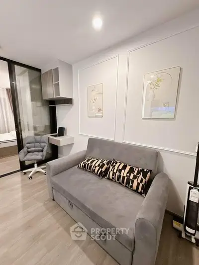 Modern living room with stylish sofa and workspace in contemporary apartment.