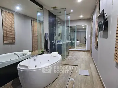 Luxurious modern bathroom with jacuzzi and glass shower enclosure