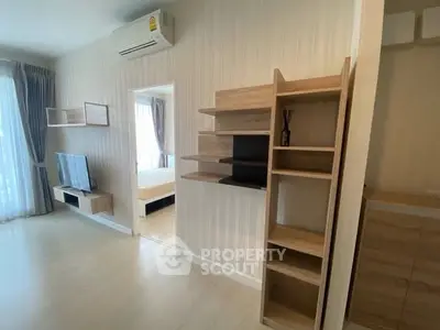 Modern apartment interior with open living area and bedroom view