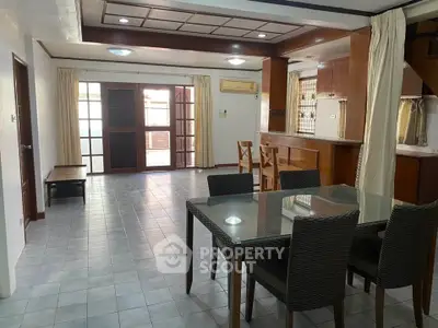 Spacious open-plan living and dining area with modern furnishings and natural light.