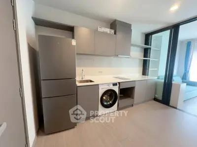 Modern kitchen with sleek cabinetry, integrated appliances, and open layout in stylish apartment.
