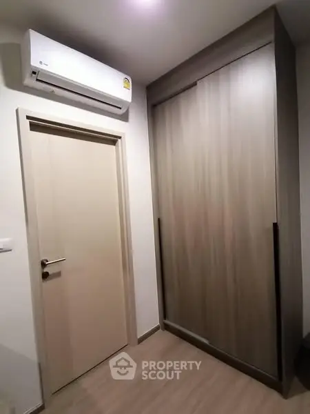 Modern interior with sleek wardrobe and air conditioning unit