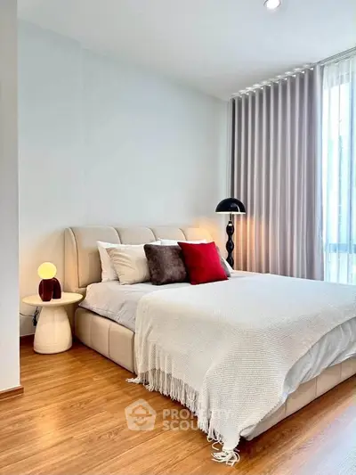 Elegant bedroom with cozy bed, stylish decor, and natural light, perfect for relaxation and comfort.